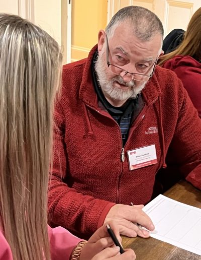 Professionals having an in-depth discussion at a BNI event.